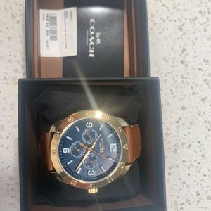 Coach - Casey gold face blue & carbon watch with light brown leather strap.